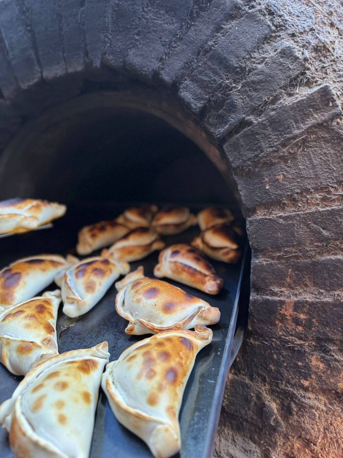 Empanadas recién horneadas en horno de barro